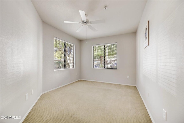 carpeted empty room featuring ceiling fan