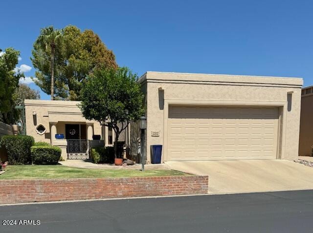 8638 E Paraiso Dr, Scottsdale, AZ 85255 - view of front of property featuring an attached garage, stucco siding, and driveway