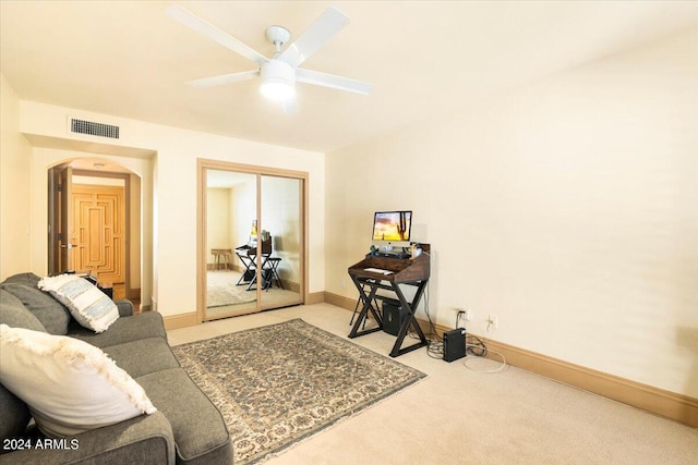8638 E Paraiso Dr, Scottsdale, AZ 85255 - living room with visible vents, light carpet, baseboards, ceiling fan, and arched walkways