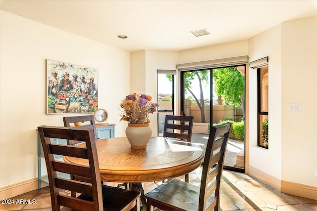 8638 E Paraiso Dr, Scottsdale, AZ 85255 - dining room with light tile patterned floors, baseboards, and visible vents