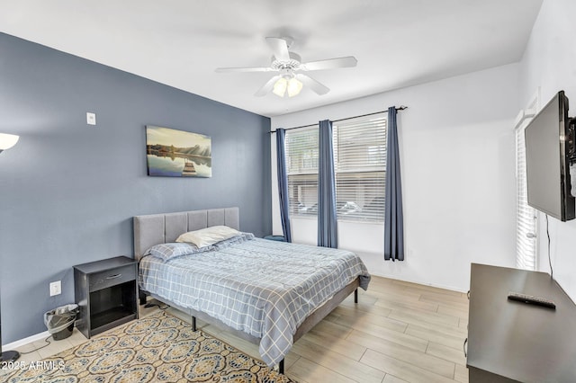 bedroom with light hardwood / wood-style flooring and ceiling fan