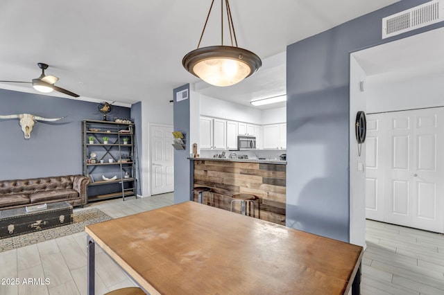 dining space featuring ceiling fan