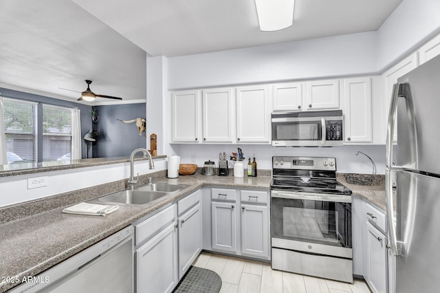 kitchen featuring sink, stainless steel appliances, white cabinets, and ceiling fan