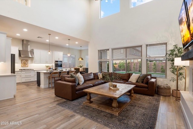 5661 S Dante, Mesa, AZ 85212 - living area featuring a towering ceiling, light wood-style floors, and recessed lighting