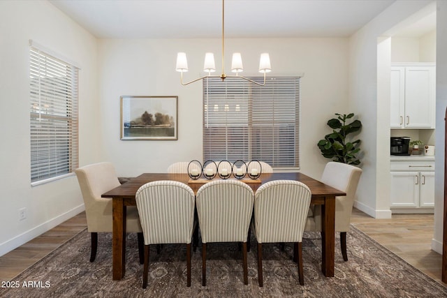 5661 S Dante, Mesa, AZ 85212 - dining area with wood finished floors, a chandelier, and baseboards