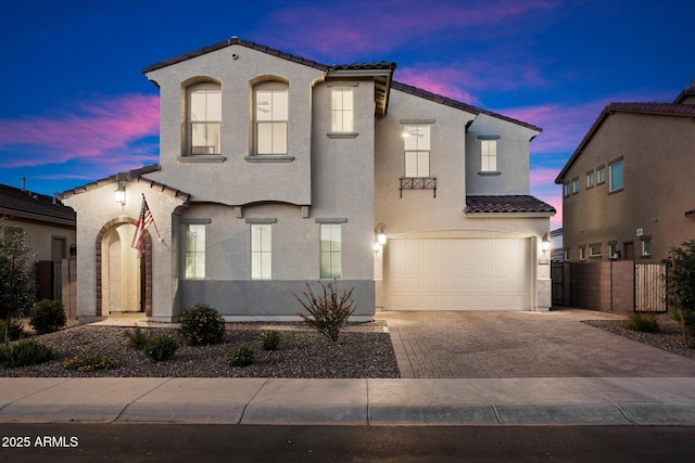 5661 S Dante, Mesa, AZ 85212 - mediterranean / spanish-style home with a tiled roof, decorative driveway, an attached garage, and stucco siding