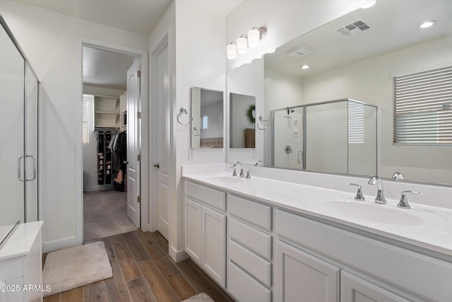 5661 S Dante, Mesa, AZ 85212 - full bathroom with a stall shower, double vanity, wood finished floors, a spacious closet, and baseboards