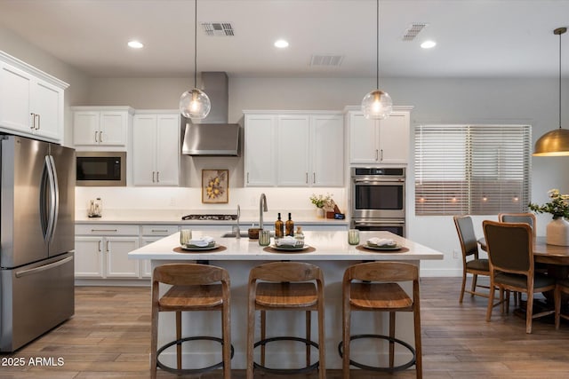 5661 S Dante, Mesa, AZ 85212 - kitchen with appliances with stainless steel finishes, a sink, a kitchen breakfast bar, light countertops, and white cabinets