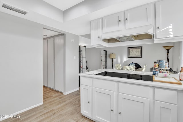 kitchen featuring white cabinets and light hardwood / wood-style flooring