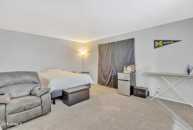 carpeted bedroom with stainless steel refrigerator