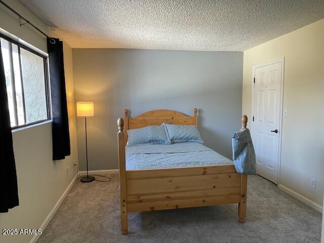 carpeted bedroom with a textured ceiling