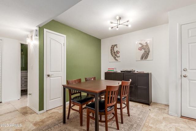 dining area featuring an inviting chandelier