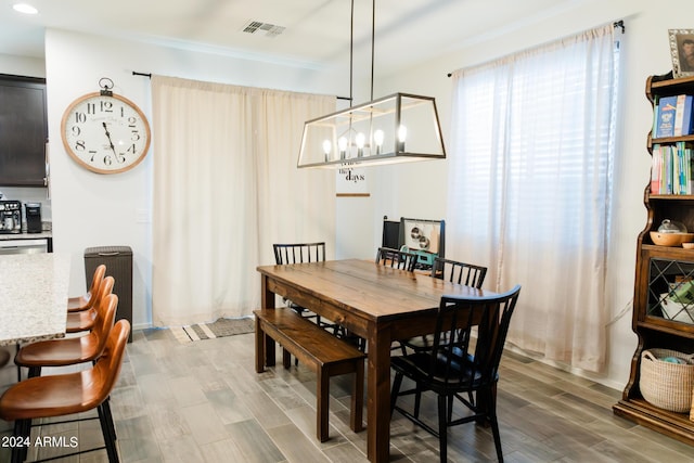 14344 W Hackamore Dr, Surprise, AZ 85387 - dining space with light wood-style floors, a chandelier, crown molding, and recessed lighting