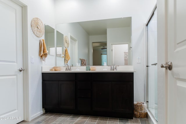 14344 W Hackamore Dr, Surprise, AZ 85387 - bathroom with double vanity, wood finished floors, and baseboards