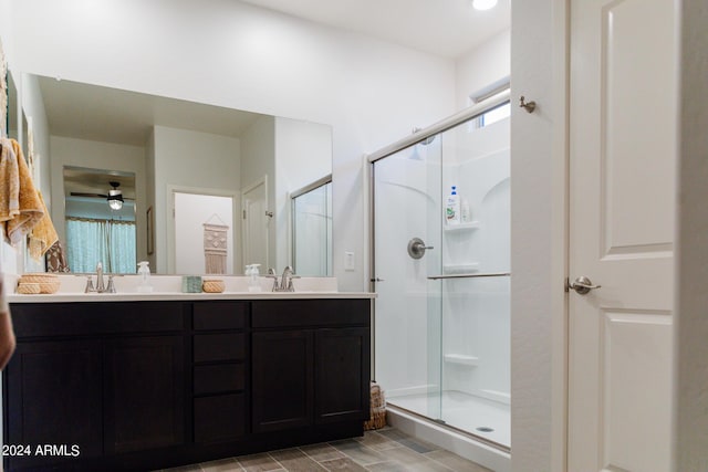 14344 W Hackamore Dr, Surprise, AZ 85387 - full bathroom with a shower stall, double vanity, plenty of natural light, and a ceiling fan