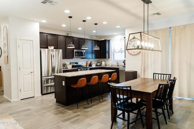 14344 W Hackamore Dr, Surprise, AZ 85387 - dining room featuring light wood-style flooring, recessed lighting, and baseboards