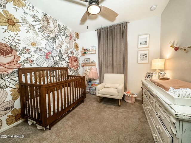 14344 W Hackamore Dr, Surprise, AZ 85387 - bedroom with a crib, light colored carpet, baseboards, and a ceiling fan