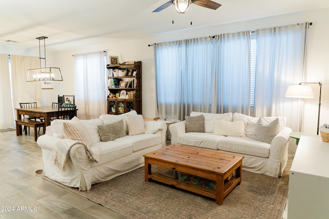14344 W Hackamore Dr, Surprise, AZ 85387 - living room featuring a chandelier, ceiling fan, and light wood finished floors