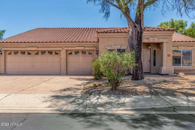 mediterranean / spanish-style home with a garage