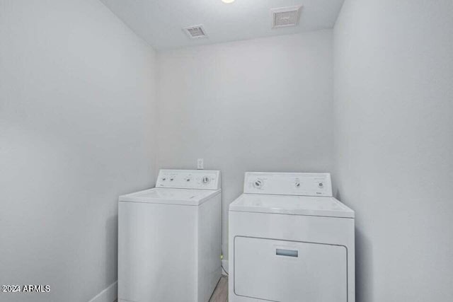 washroom with washing machine and clothes dryer