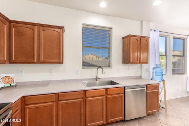 kitchen with sink, light tile patterned flooring, and stainless steel appliances