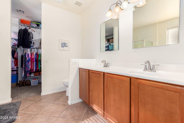 bathroom featuring toilet, vanity, and tile patterned floors