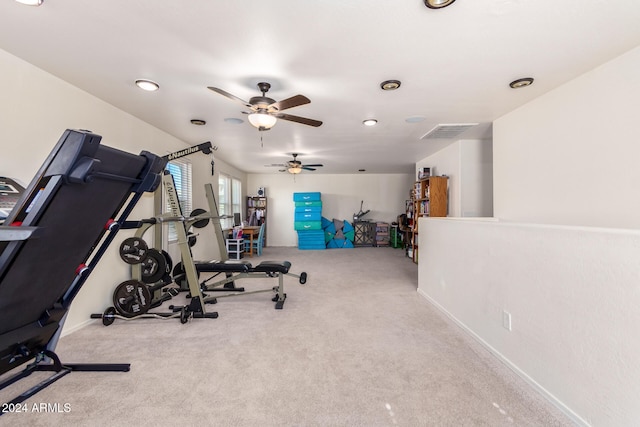 exercise room featuring ceiling fan and light carpet