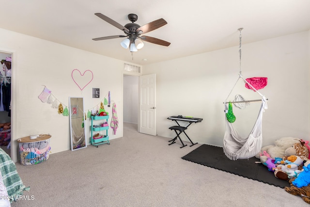 game room with ceiling fan and carpet flooring