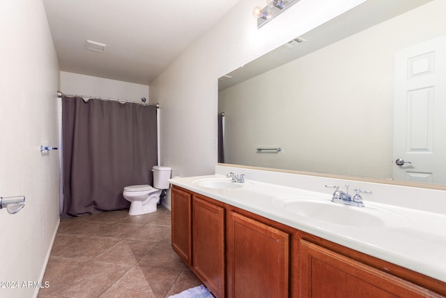 bathroom with tile patterned flooring, vanity, and toilet