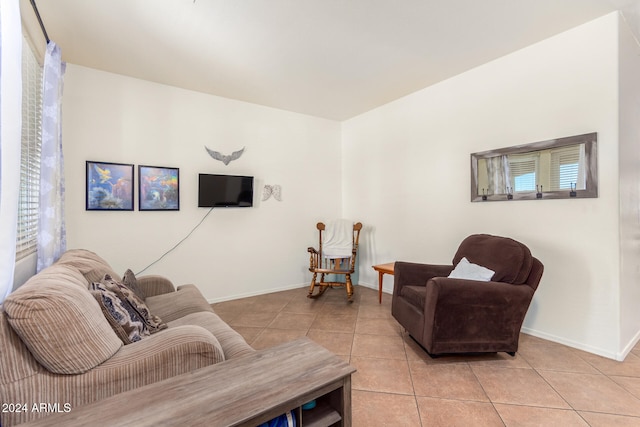 tiled living room featuring a healthy amount of sunlight