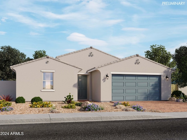 mediterranean / spanish-style house with driveway, a tiled roof, an attached garage, and stucco siding