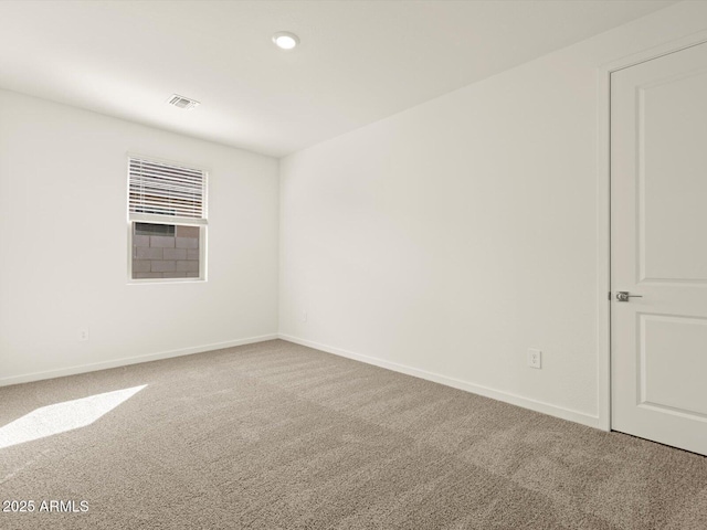 carpeted empty room with baseboards and recessed lighting