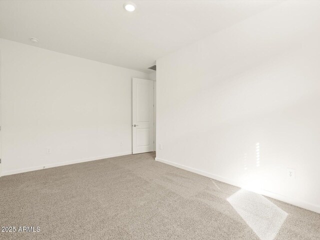 spare room with carpet flooring, baseboards, and recessed lighting