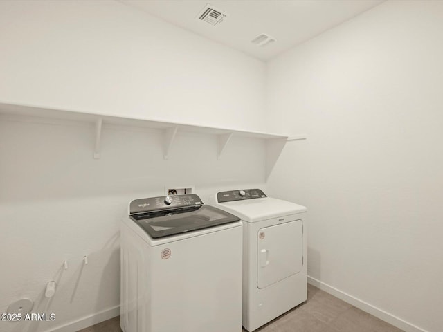 washroom featuring independent washer and dryer and baseboards