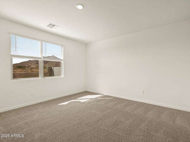 spare room with carpet flooring, baseboards, and recessed lighting