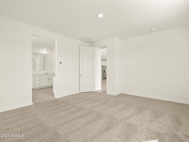 unfurnished room featuring light colored carpet, baseboards, and recessed lighting