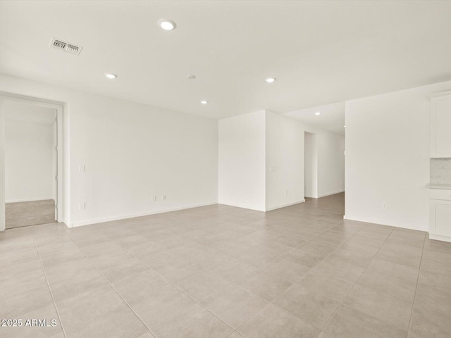 empty room featuring recessed lighting and light tile patterned floors