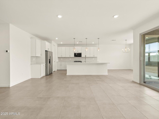 unfurnished living room featuring recessed lighting, a sink, light tile patterned flooring, a chandelier, and baseboards