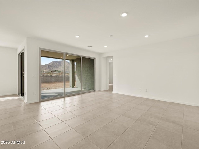 unfurnished room with light tile patterned flooring, recessed lighting, and baseboards