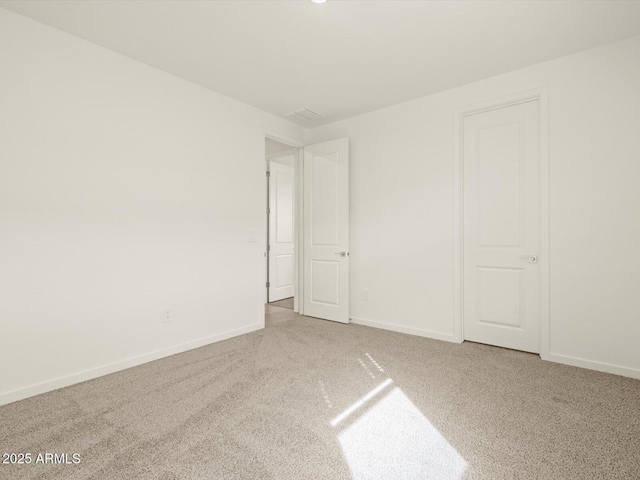 unfurnished bedroom featuring carpet flooring and baseboards