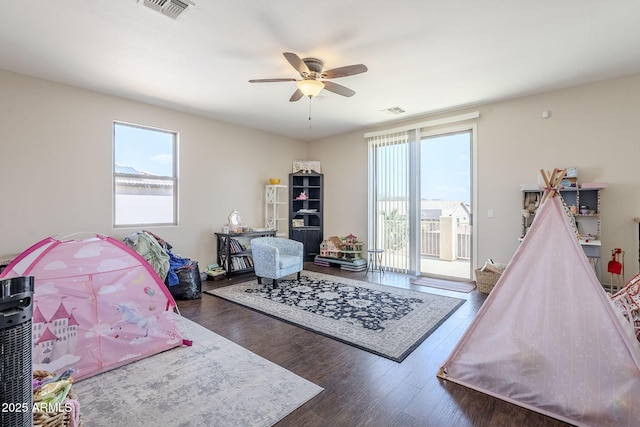 recreation room featuring a wealth of natural light, visible vents, and wood finished floors