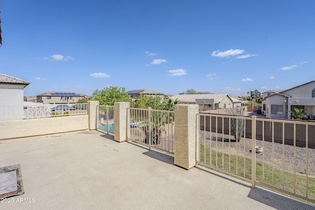 view of gate featuring a residential view and fence