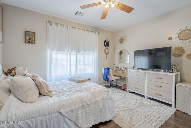 bedroom featuring dark wood-style flooring, visible vents, and a ceiling fan