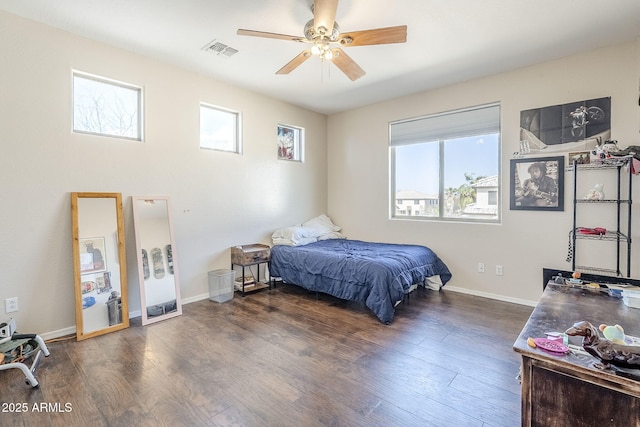 bedroom with visible vents, ceiling fan, baseboards, and wood finished floors