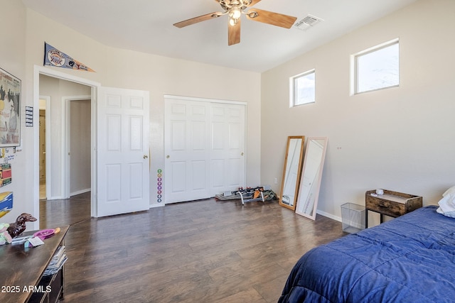 bedroom with ceiling fan, dark wood-type flooring, visible vents, and baseboards