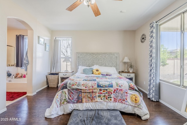 bedroom featuring arched walkways, wood finished floors, a ceiling fan, and baseboards