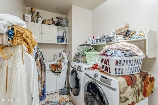 washroom featuring washer and clothes dryer, light tile patterned flooring, and cabinet space