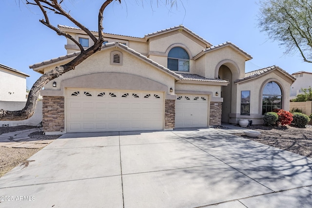 mediterranean / spanish house featuring stone siding, a tile roof, driveway, and stucco siding