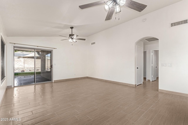 unfurnished room with ceiling fan and vaulted ceiling