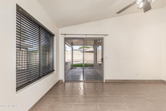 empty room with ceiling fan and lofted ceiling